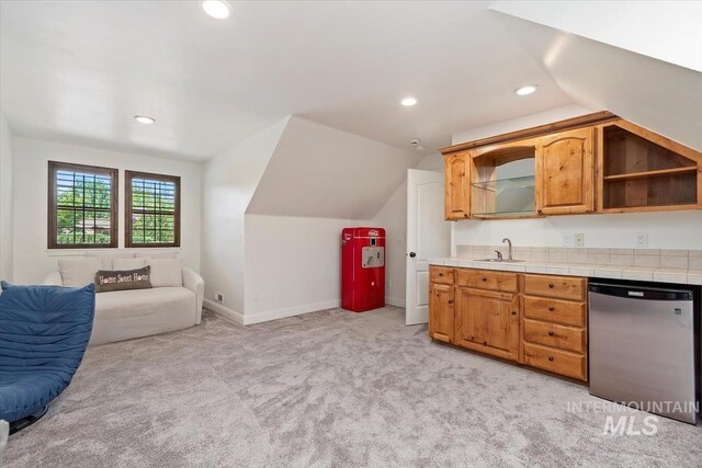 1512 E Rivers End Ct, Eagle, ID 83616 - kitchen featuring dishwasher, light colored carpet, tile counters, lofted ceiling, and recessed lighting