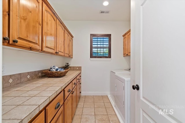1512 E Rivers End Ct, Eagle, ID 83616 - laundry area with cabinet space, washing machine and clothes dryer, light tile patterned flooring, and recessed lighting