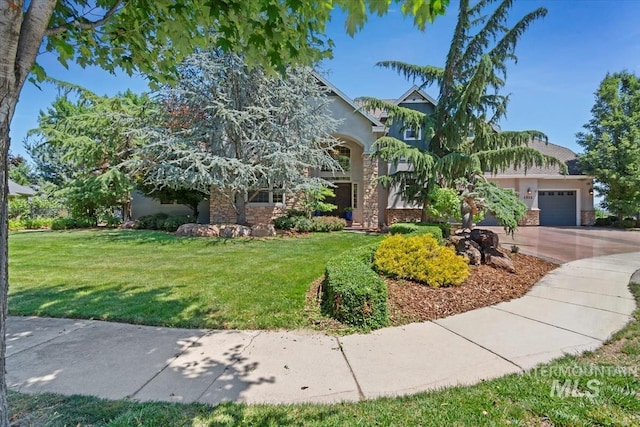 1512 E Rivers End Ct, Eagle, ID 83616 - obstructed view of property with stucco siding, a front yard, an attached garage, driveway, and stone siding