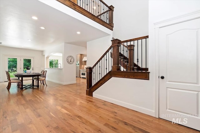 1512 E Rivers End Ct, Eagle, ID 83616 - stairway featuring arched walkways, recessed lighting, wood finished floors, and french doors