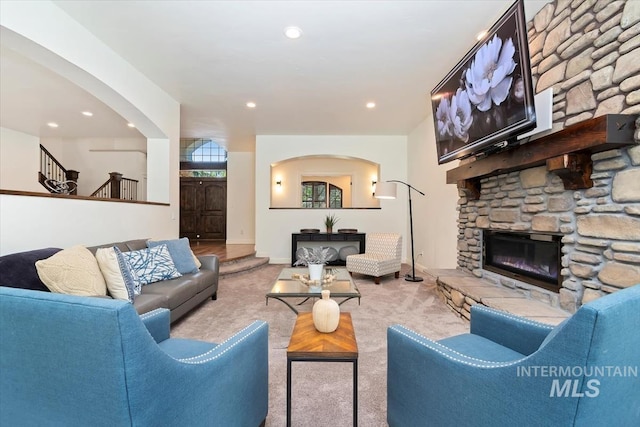 1512 E Rivers End Ct, Eagle, ID 83616 - carpeted living area with a fireplace, arched walkways, recessed lighting, and stairs