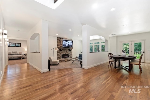 1512 E Rivers End Ct, Eagle, ID 83616 - dining space featuring a fireplace, light wood-type flooring, and arched walkways