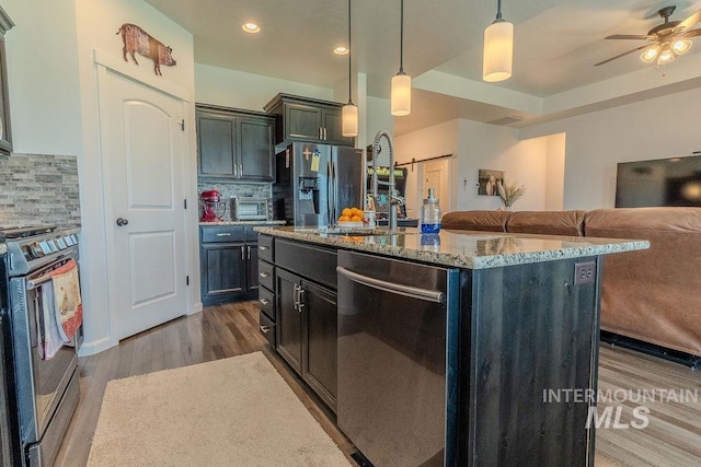 150 Cayuse Creek Dr, Kimberly, ID 83341 - kitchen featuring stainless steel appliances, light stone counters, backsplash, ceiling fan, and recessed lighting