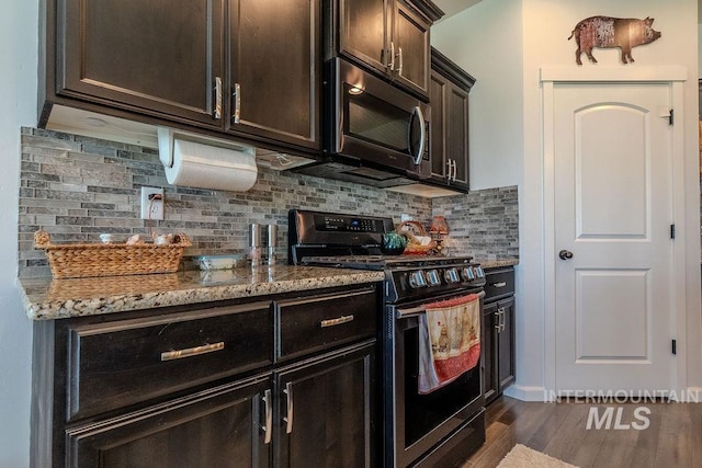 150 Cayuse Creek Dr, Kimberly, ID 83341 - kitchen featuring range with gas cooktop, stainless steel microwave, light stone countertops, dark wood-type flooring, and backsplash