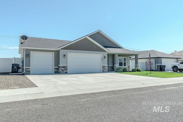 150 Cayuse Creek Dr, Kimberly, ID 83341 - view of front of property featuring a garage, stone siding, concrete driveway, and roof with shingles