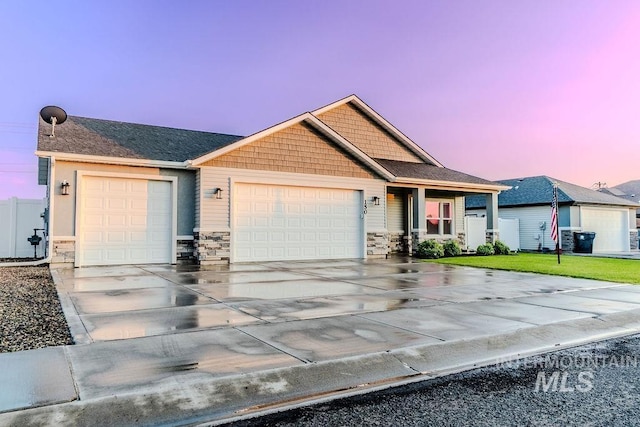 150 Cayuse Creek Dr, Kimberly, ID 83341 - view of front facade with a garage, concrete driveway, stone siding, and a yard
