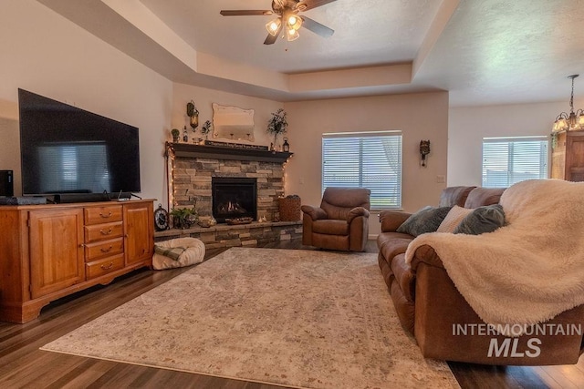 150 Cayuse Creek Dr, Kimberly, ID 83341 - living area with wood finished floors, ceiling fan, a fireplace, and a tray ceiling