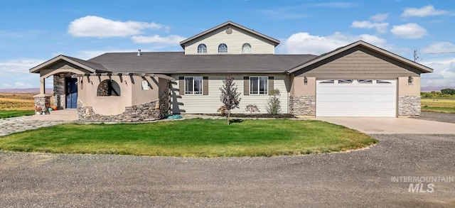 view of front of home with a garage and a front yard