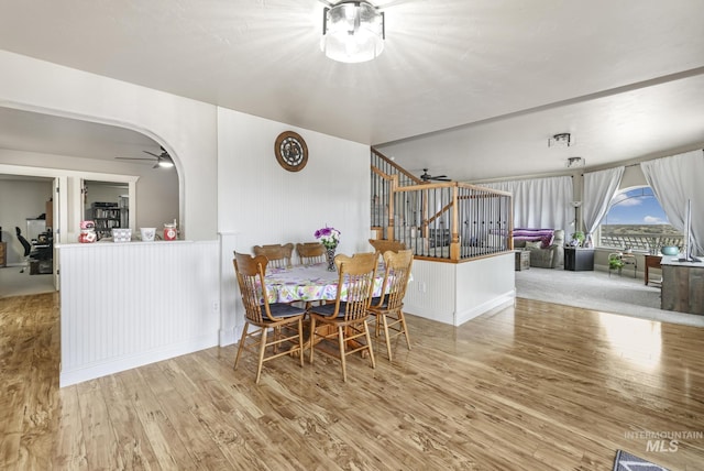 dining space with ceiling fan and light wood-type flooring