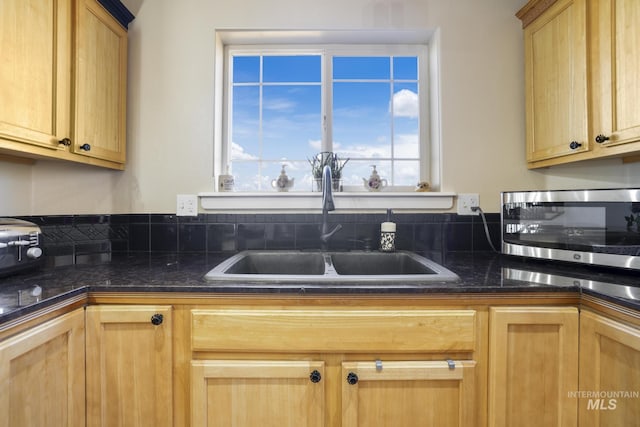 kitchen featuring light brown cabinetry and sink