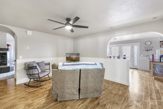living room with ceiling fan and light wood-type flooring
