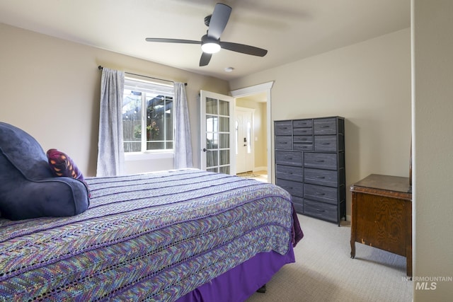 bedroom featuring light colored carpet and ceiling fan