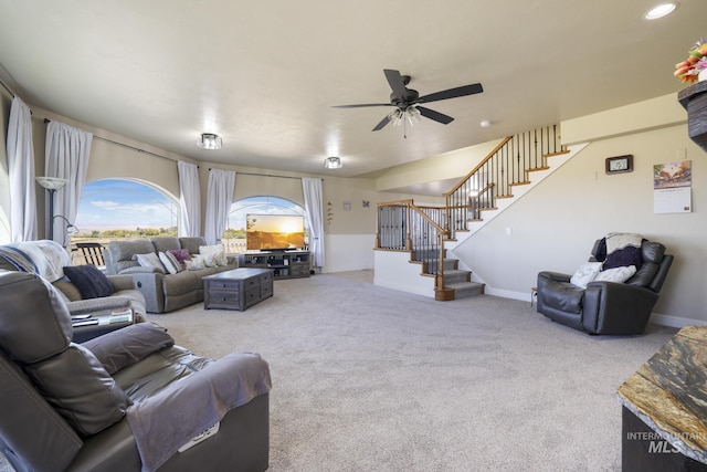 living room featuring ceiling fan and carpet
