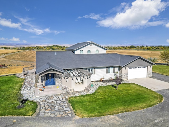 view of front of home featuring a garage and a front lawn