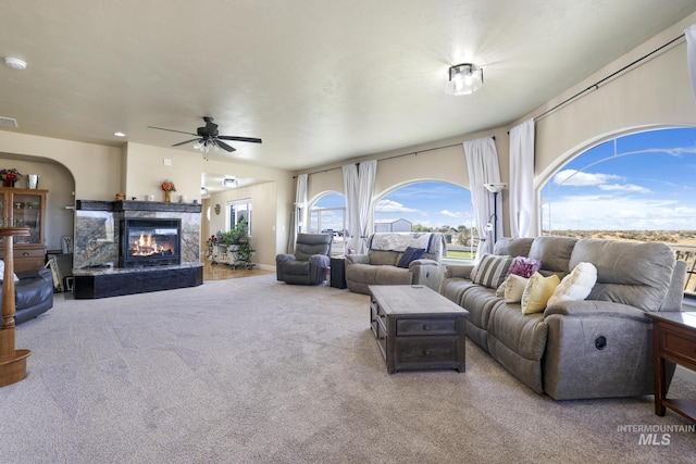 living room with light colored carpet and ceiling fan