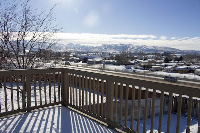 snow covered deck featuring a mountain view