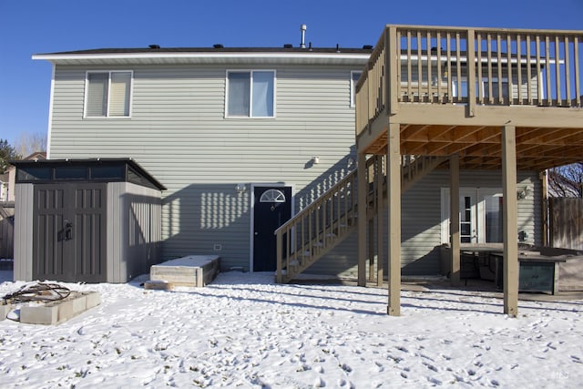 snow covered house featuring a deck