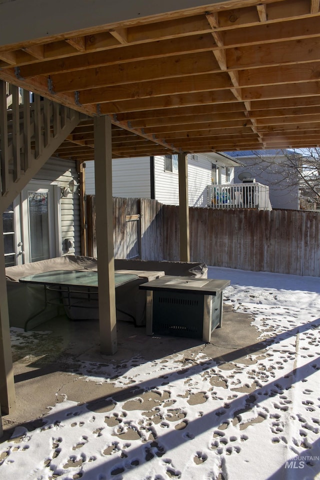 snow covered patio featuring a fire pit