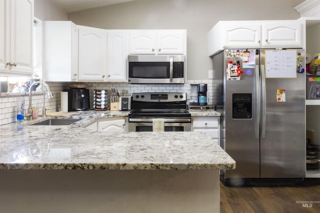 kitchen featuring sink, light stone counters, white cabinets, and stainless steel appliances