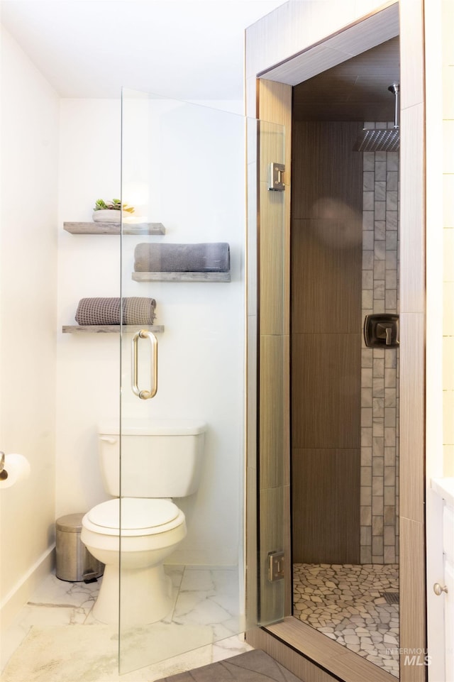 bathroom featuring toilet and walk in shower