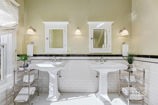 bathroom with tile patterned floors, tile walls, and a wainscoted wall
