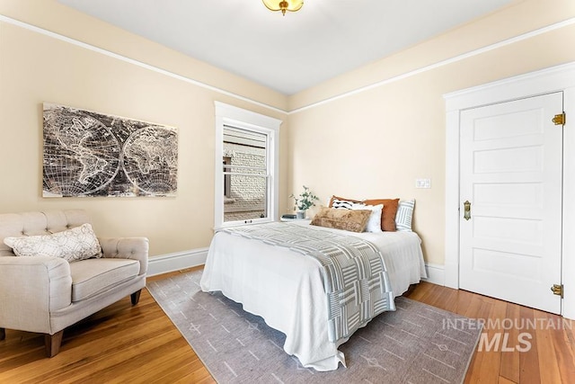 bedroom featuring baseboards and hardwood / wood-style flooring