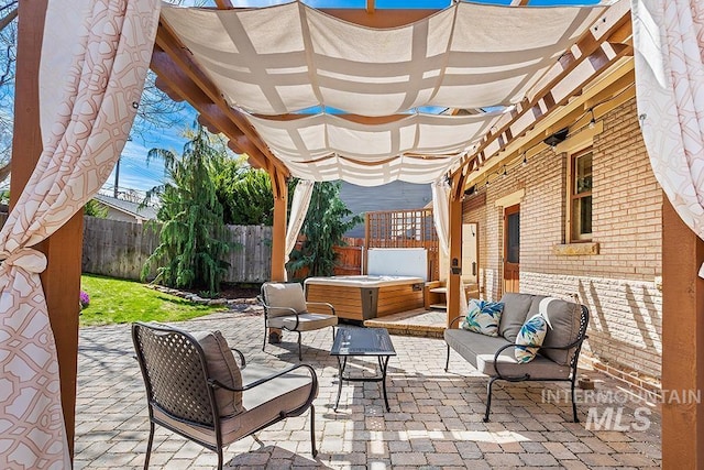 view of patio featuring an outdoor living space, a fenced backyard, a hot tub, and a pergola
