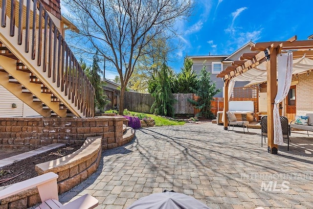 view of patio with a fenced backyard, stairs, a hot tub, and a pergola