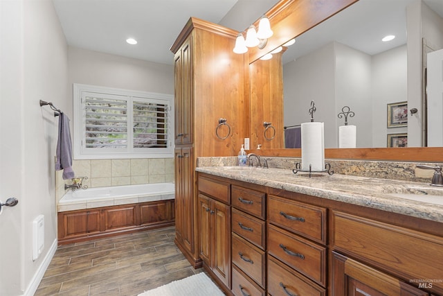 9 Autumn Blaze Ln, Salmon, ID 83467 - bathroom featuring double vanity, a garden tub, wood finished floors, and recessed lighting