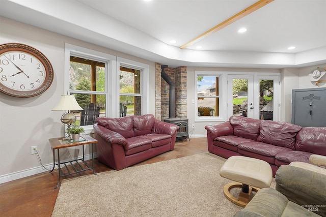 9 Autumn Blaze Ln, Salmon, ID 83467 - living room with a wood stove, recessed lighting, baseboards, french doors, and finished concrete flooring
