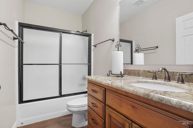 9 Autumn Blaze Ln, Salmon, ID 83467 - full bathroom with vanity, toilet, and bath / shower combo with glass door