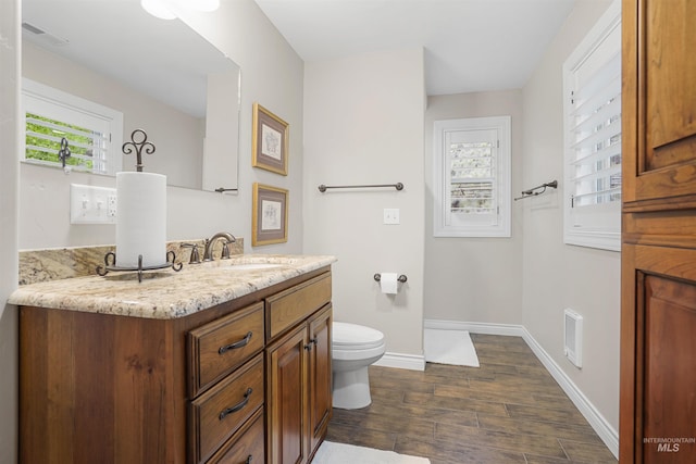 9 Autumn Blaze Ln, Salmon, ID 83467 - bathroom featuring vanity, wood finished floors, toilet, and baseboards