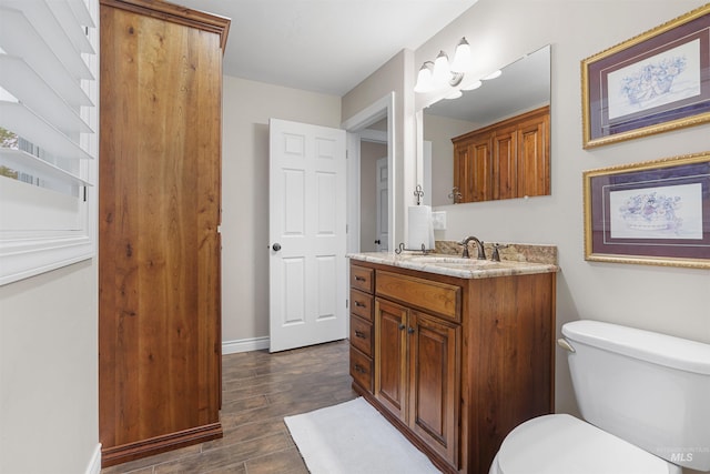 9 Autumn Blaze Ln, Salmon, ID 83467 - bathroom with vanity, wood finished floors, toilet, and baseboards