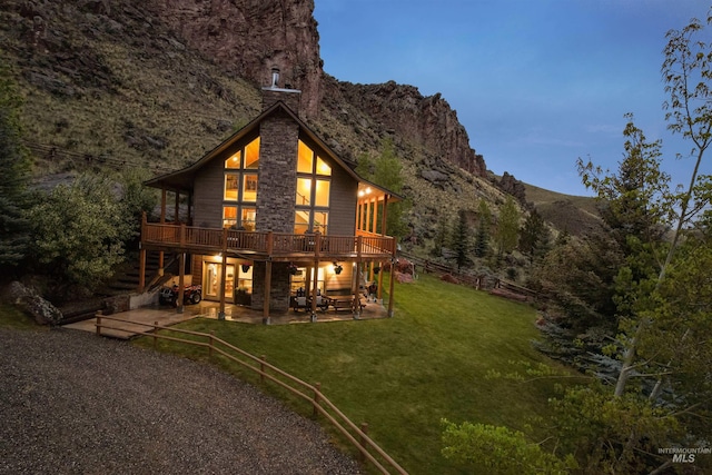 9 Autumn Blaze Ln, Salmon, ID 83467 - rear view of house featuring a patio area, a deck with mountain view, a chimney, and stairs