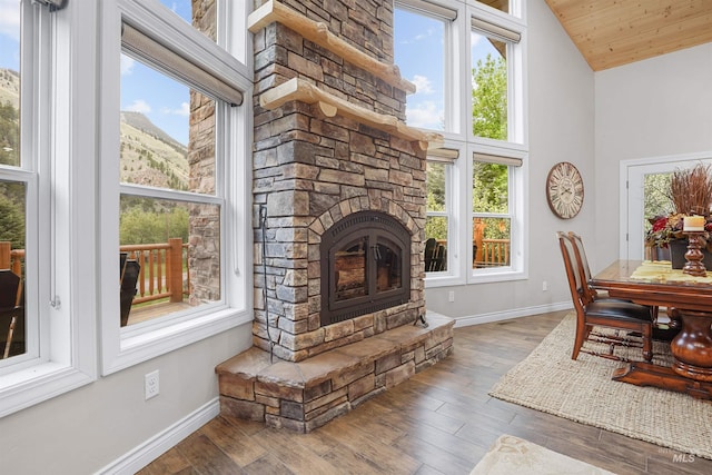 9 Autumn Blaze Ln, Salmon, ID 83467 - living room featuring baseboards, a fireplace, wood finished floors, wood ceiling, and high vaulted ceiling