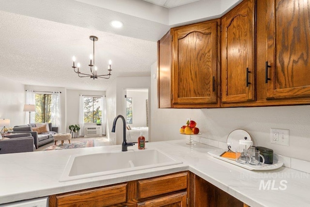 122 N Washington, Moscow, ID 83843 - kitchen featuring a sink, light countertops, a notable chandelier, and brown cabinets