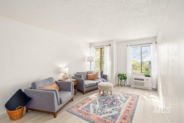 122 N Washington, Moscow, ID 83843 - living area featuring a textured ceiling, cooling unit, and wood finished floors
