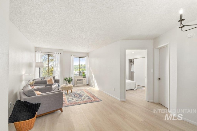 122 N Washington, Moscow, ID 83843 - living room featuring light wood finished floors, a textured ceiling, and baseboards