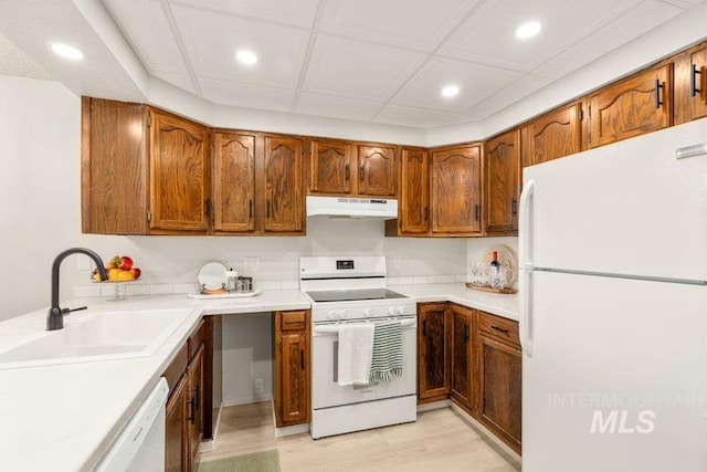 122 N Washington, Moscow, ID 83843 - kitchen with white appliances, under cabinet range hood, recessed lighting, and a sink