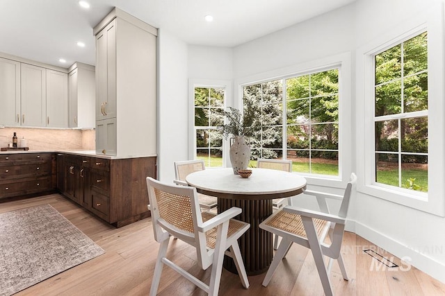 dining area featuring light wood finished floors, plenty of natural light, and recessed lighting