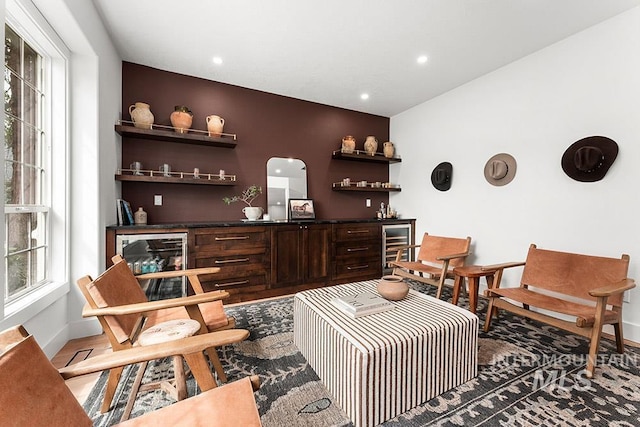 living area with plenty of natural light, baseboards, arched walkways, and recessed lighting