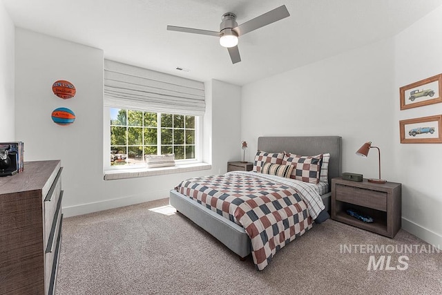 bedroom with carpet flooring, baseboards, and ceiling fan
