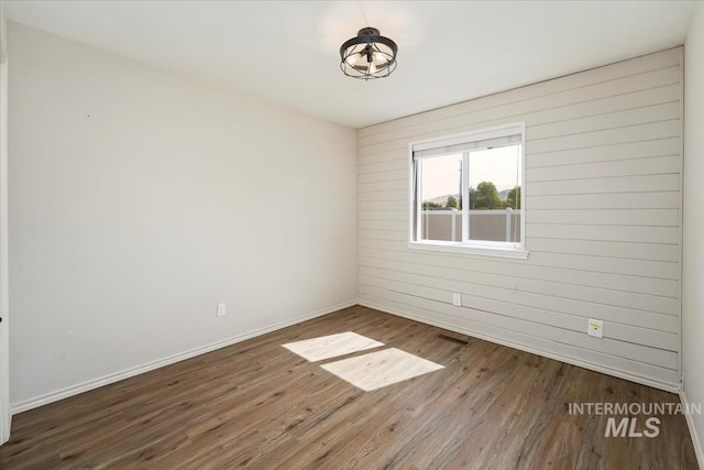 940 S Prospect Peak Way, Emmett, ID 83617 - spare room featuring baseboards, wood finished floors, and wood walls