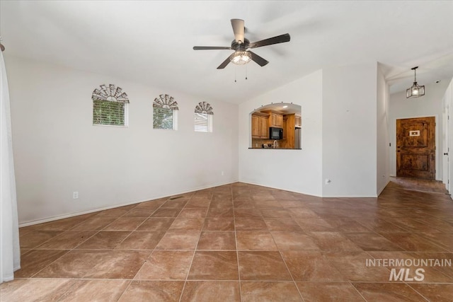 940 S Prospect Peak Way, Emmett, ID 83617 - empty room with ceiling fan, vaulted ceiling, tile patterned floors, and baseboards