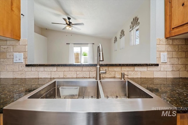 940 S Prospect Peak Way, Emmett, ID 83617 - kitchen with brown cabinets, ceiling fan, tasteful backsplash, a sink, and vaulted ceiling