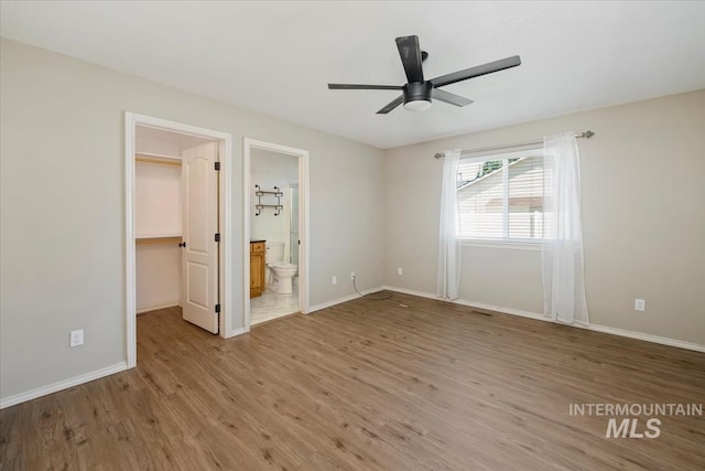 940 S Prospect Peak Way, Emmett, ID 83617 - unfurnished bedroom featuring a spacious closet, wood finished floors, and baseboards
