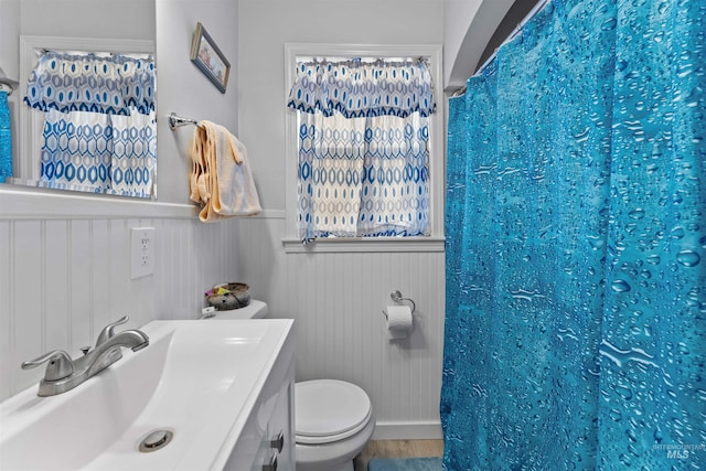 bathroom with toilet, hardwood / wood-style flooring, vanity, and a shower with curtain