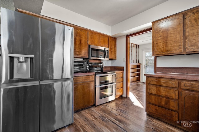 kitchen with dark wood-type flooring and appliances with stainless steel finishes