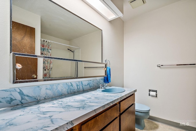 bathroom featuring vanity, curtained shower, tile patterned floors, and toilet