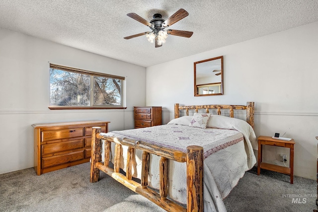 carpeted bedroom with ceiling fan and a textured ceiling